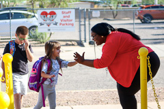 Each child is met with a friendly greeting.  High five!