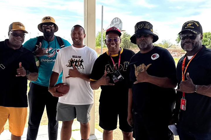 A group of fraternity brothers smile for a photo
