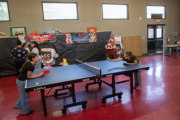 Two girls play ping-pong