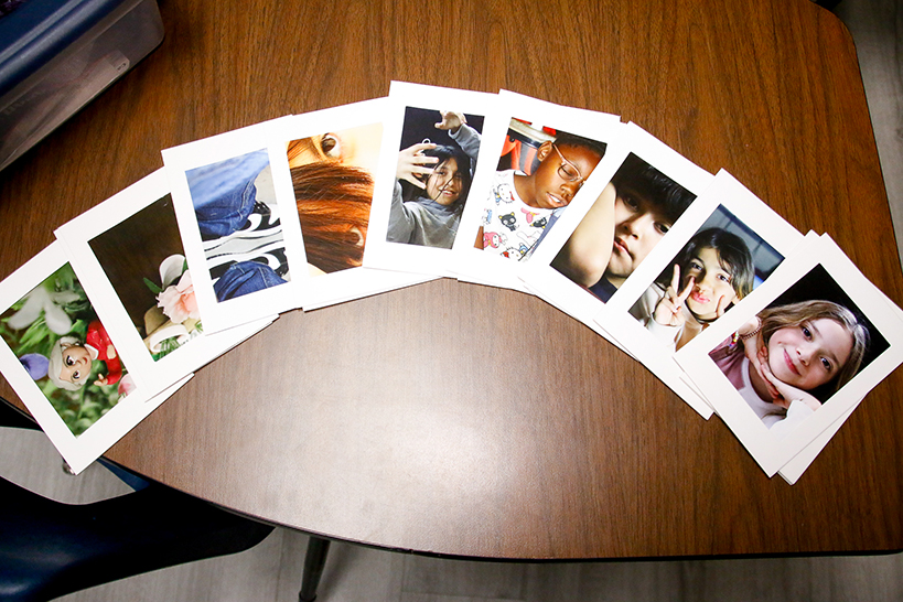 A display of student photographs on a table