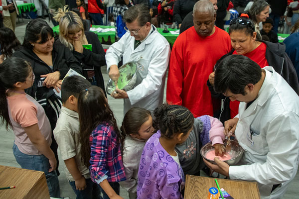 Several children and adults watched close-up as scientists mixed up a batch of slime