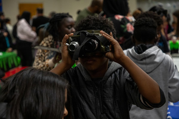A student tries on a pair of Ghostbuster goggles